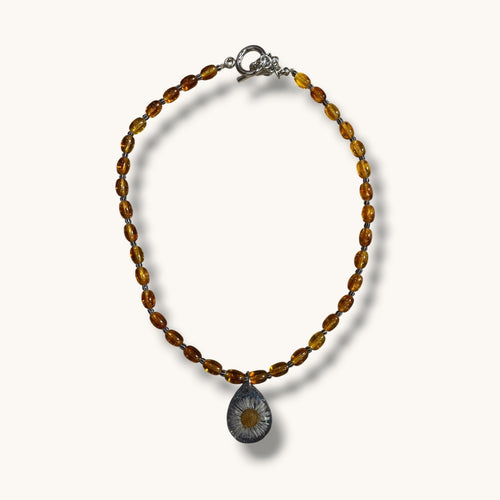 Teardrop resin pendant with a real white daisy flower on an amber beaded choker necklace with a silver toggle clasp